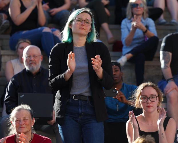 Woman claps during vigil speech.JPG