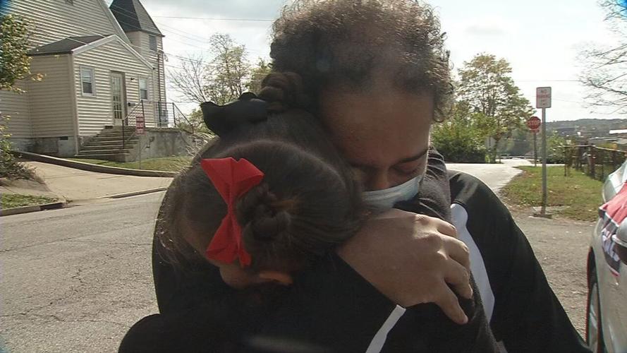 Demetrius Booker hugs his daughter after returning home from his 3-month-battle with COVID-19