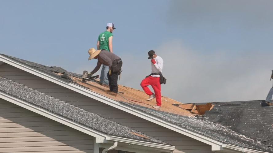 Workers repair roof on Sellersburg home damaged by EF-0 tornado