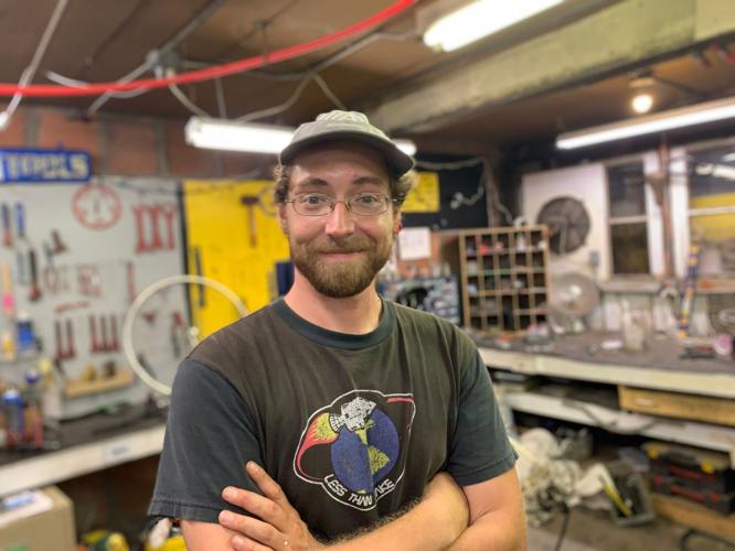 Nathan Green smiles inside bike shop