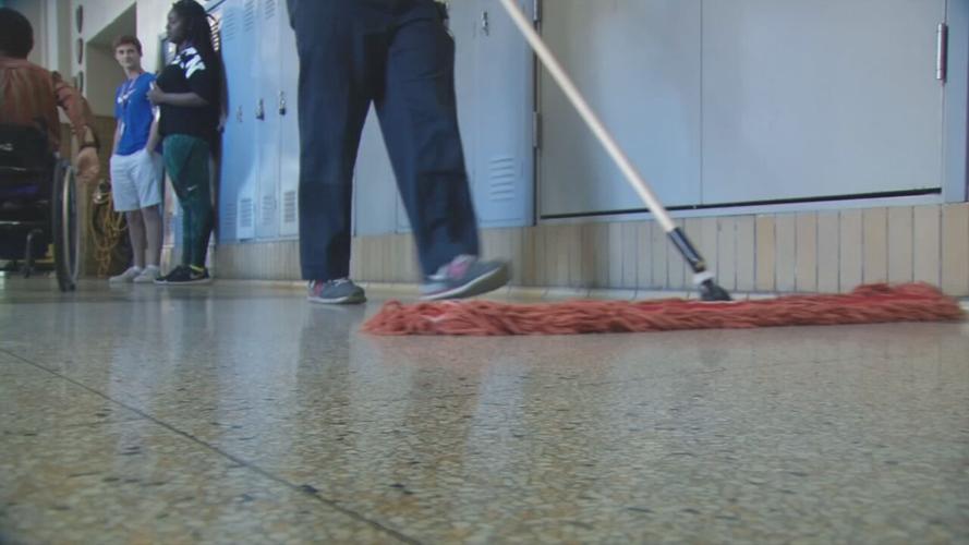 Custodian cleaning a school hallway (generic)