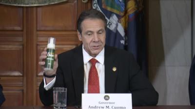 Andrew Cuomo with hand sanitizer