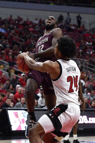 Louisville forward Dwayne Sutton (24) strips the ball away from Eastern Kentucky guard Ty Taylor II