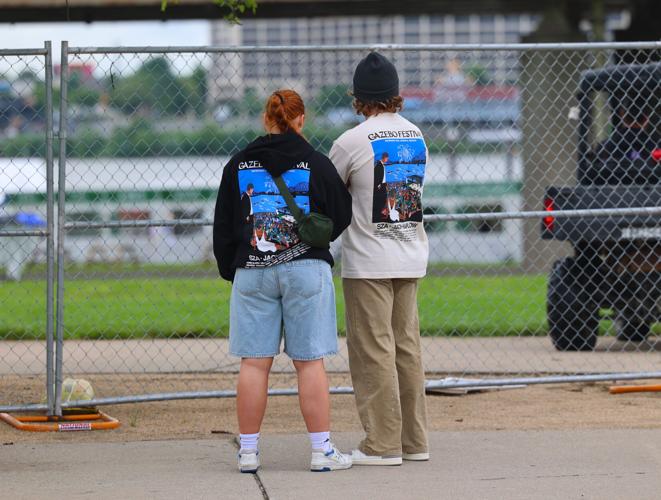 Two people look inside Gazebo Fest after it was canceled.JPG