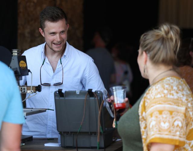 Vendor hands drink to woman at Bourbon and Beyond