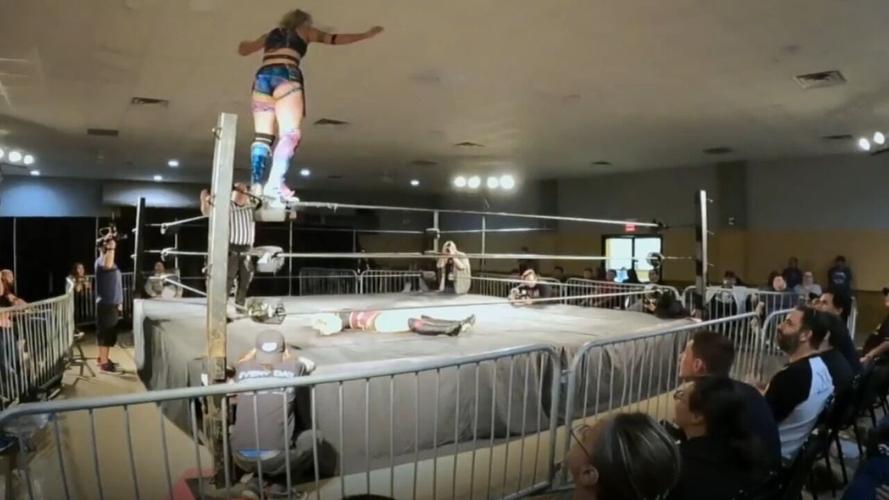 Wrestler Billie Starkz stands on top of ring