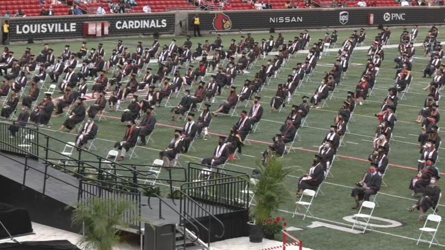 Graduates sit at ceremony at Cardinal Stadium.jpeg