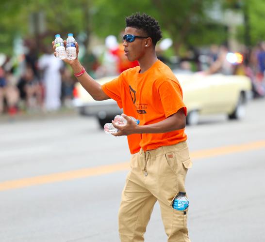 Shane Crowe hands out water bottles.JPG