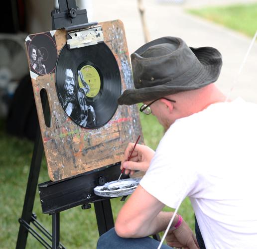 Man paints vinyls at Abbey Road on the River.JPG