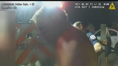 Lannie Fentress being escorted by officers