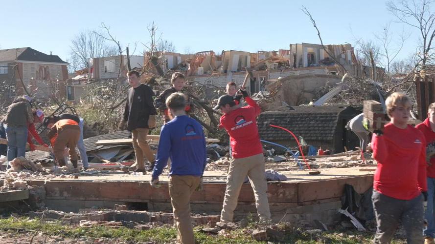 Volunteers help clean debris from properties in Warren County on Monday, Dec. 13, 2021.