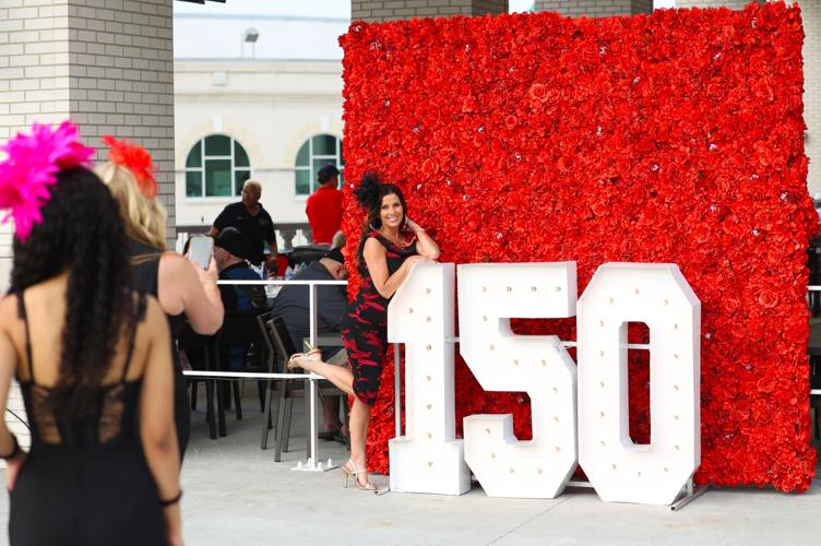 Woman poses with Kentucky Derby 150 sign.JPG