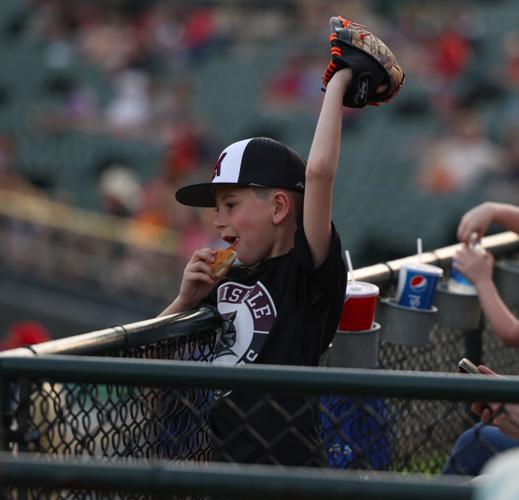 Child eats a hot dog with glove.JPG