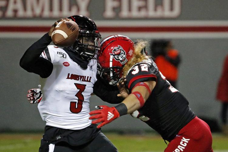 North Carolina State's Drake Thomas (32) sacks Louisville quarterback Micale Cunningham
