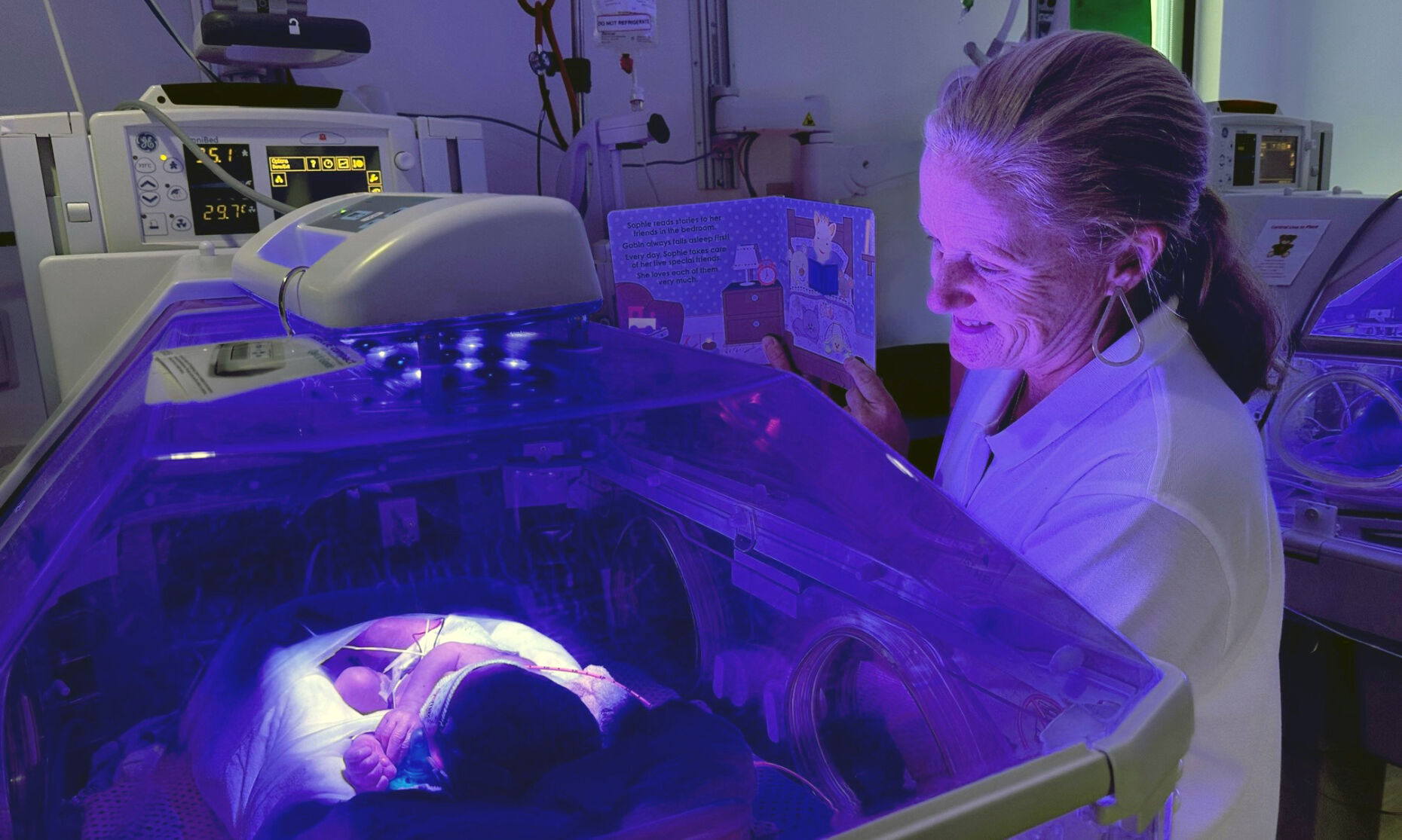 Baptist Health Louisville volunteer Christine Shenk reads to NICU baby