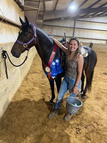 Savannah Duckworth poses with an award winning horse.