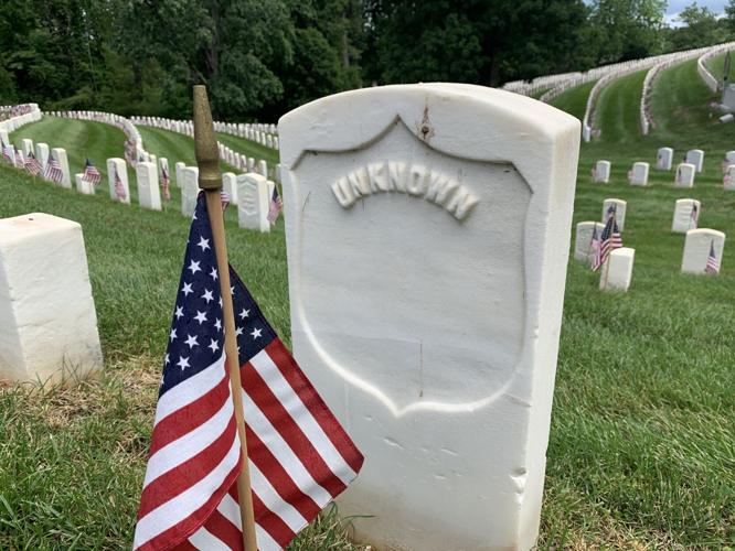 Flags placed on the graves of veterans at Cave Hill Cemetery on Friday, May 27, 2022