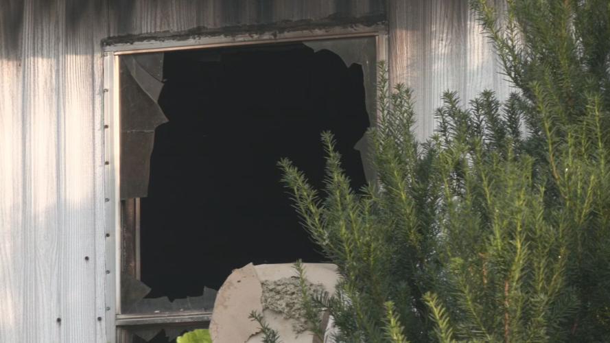 Broken window in Madison, Indiana, mobile home after fatal fire