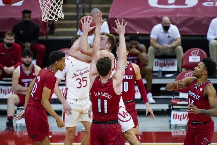 Wisconsin's Tyler Wahl (5) shoots against Louisville's Quinn Slazinski