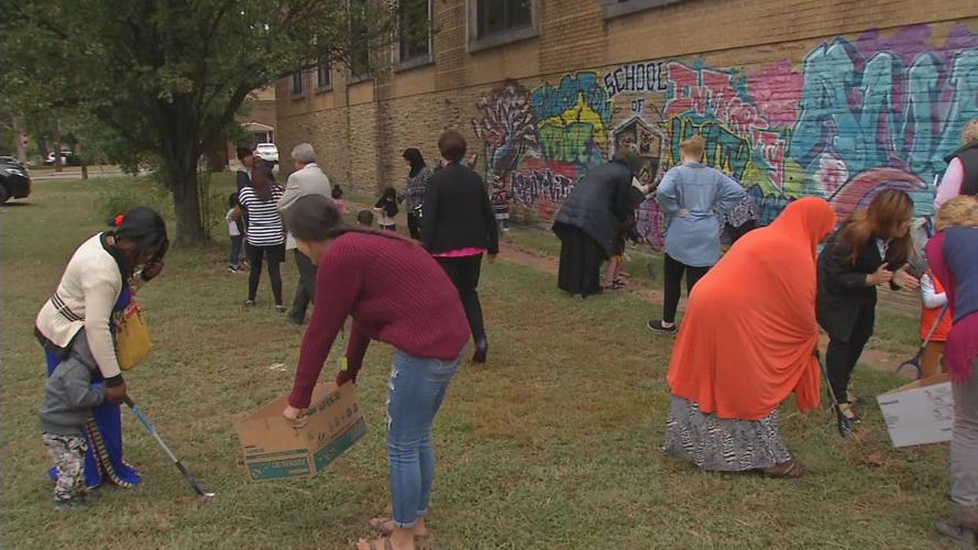 Immigrants performing a service project at Americana Community Center