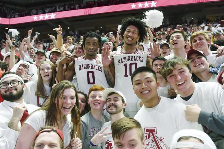 Arkansas players Stanley Umude and Jaylin Williams celebrate with fans.jpeg