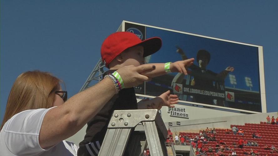 4-year-old boy with Down syndrome leads Cardinal Marching Band during halftime performance