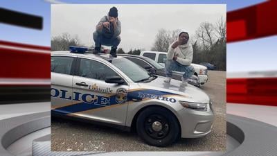 Jan. 27, 2020 image of 2 people standing on LMPD cruiser