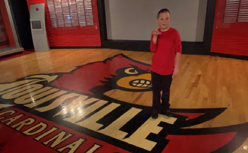 Kammerer Middle School student Noah Mattingly throws an 'L'