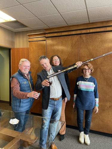 Frazier History Museum pours bourbon from rifle decanter