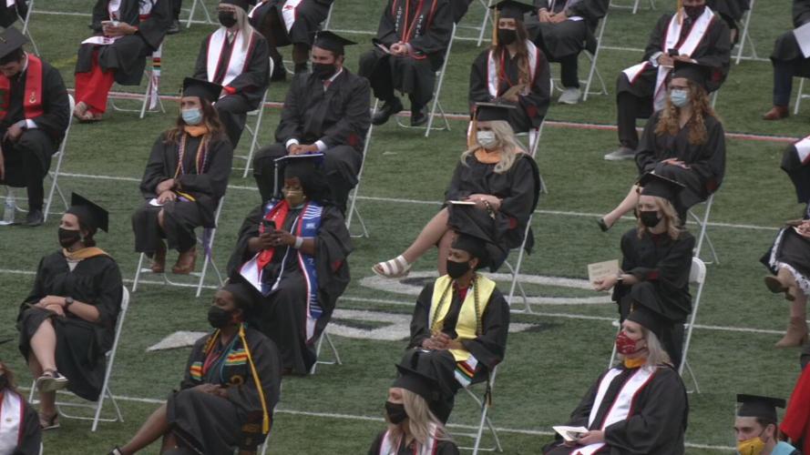 Graduates sit at Cardinal Stadium during ceremony.jpeg