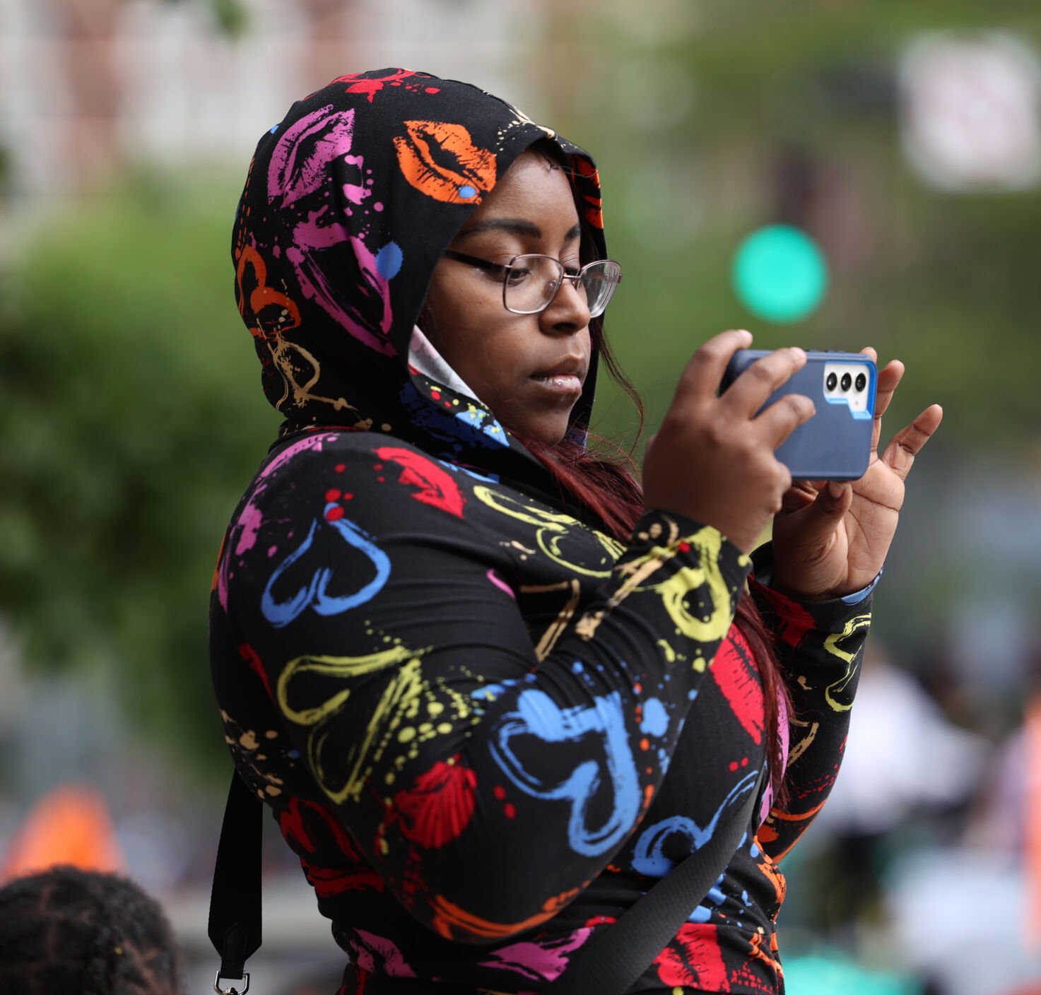 Girl takes video at parade.JPG