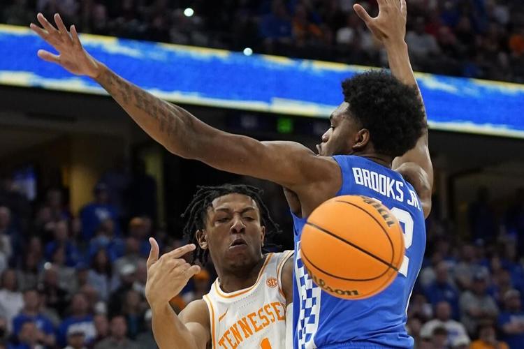 Tennessee guard Kennedy Chandler passes the ball around Kentucky forward Keion Brooks Jr.jpeg