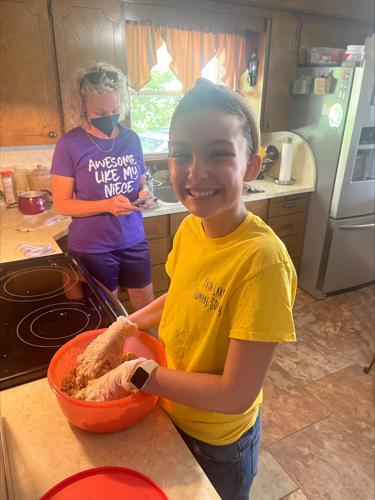 Alexis Bibb prepares food in kitchen