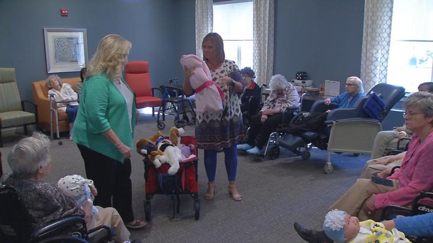 Senior with baby doll brought by Pearl's Memory Babies