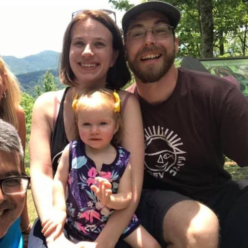 Nathan Green smiles alongside partner Hannah and daughter Ronan