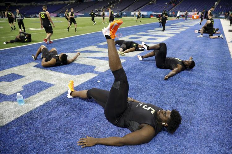 Louisville offensive lineman Mekhi Becton stretches at the NFL football scouting combine