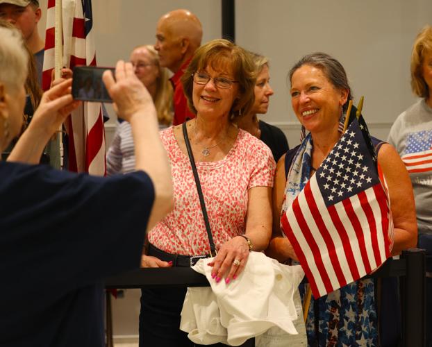Two women pose for cell phone photo at Honor Flight Return Home.JPG