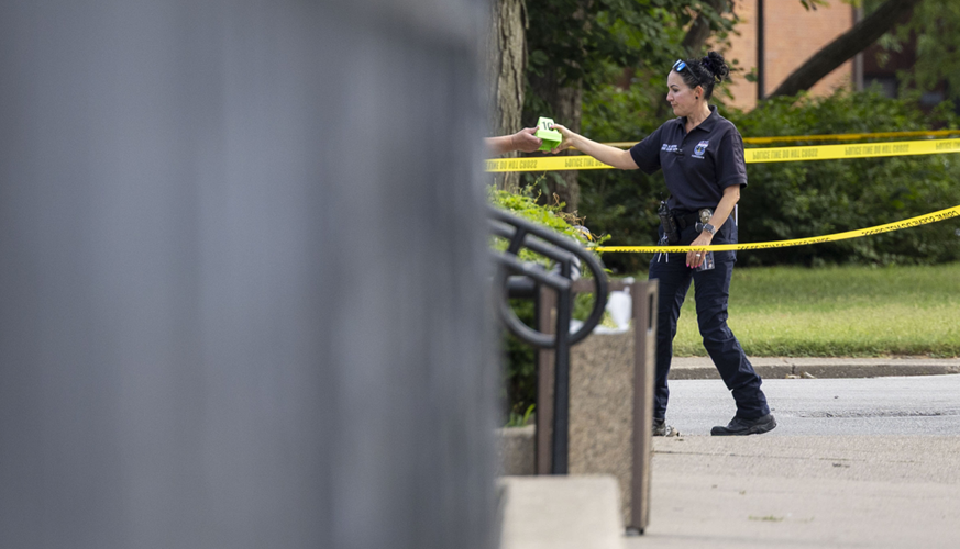LMPD officer with crime tape near Chestnut Street shooting