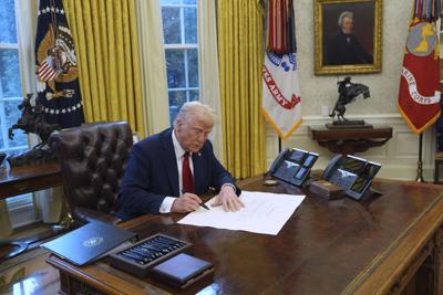 President Donald Trump signs executive orders in the Oval 1-30-2025