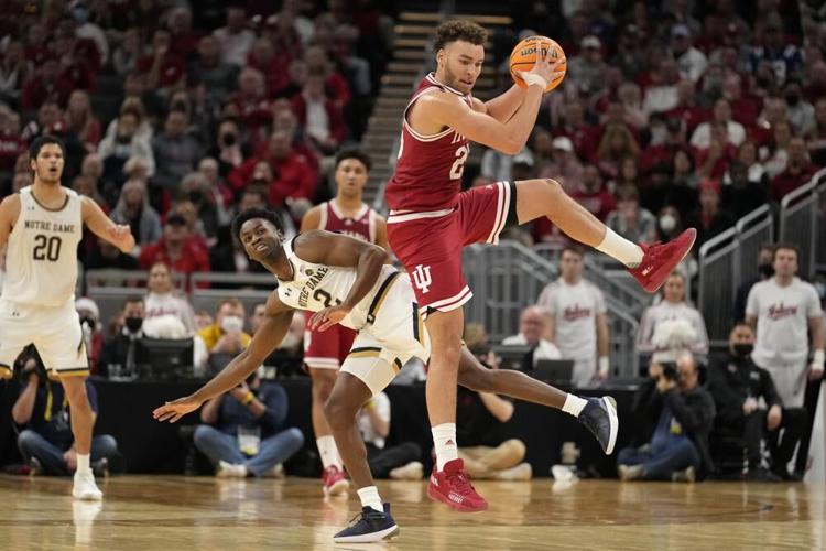 Indiana forward Race Thompson catches a pass ahead of Notre Dame guard Trey Wertz.jpeg