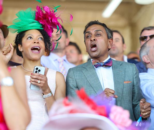 Man cheers on horses at Oaks.JPG