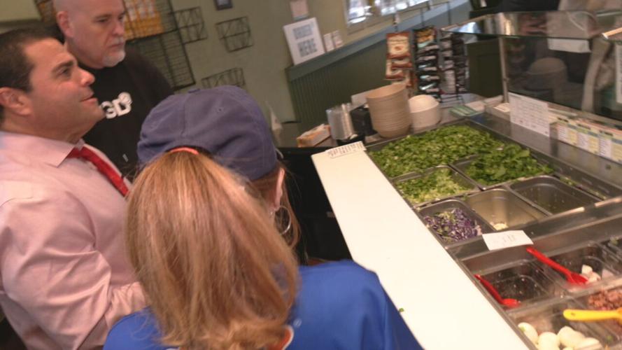 Darryl Isaacs in front of salads at the Green District