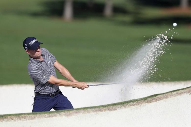 Justin Thomas hits out of the bunker on the 7th green during the second round of the Masters Friday