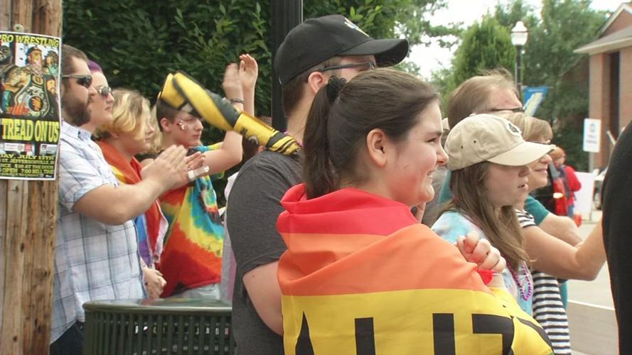 Festivalgoers watch the Southern Indiana Pride Parade