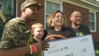 David Turner Jr. and his family being presented $1,000 check