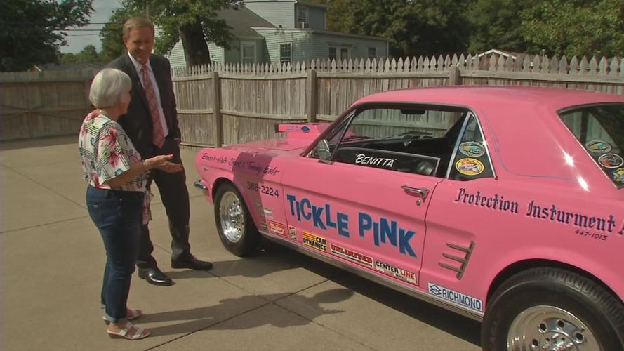 Benitta Russell shows WDRB's Scott Reynolds her racing car, Tickle Pink