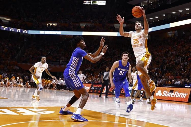 Tennessee guard Santiago Vescovi shoots a layup past Kentucky guard Sahvir Wheelrand.jpeg