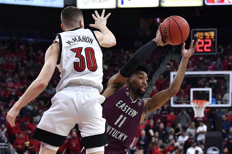 Eastern Kentucky guard Jomaru Brown (11) attempts to pass the ball as Louisville guard Ryan McMahon