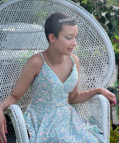 Alexis Bibb poses in white whicker chair