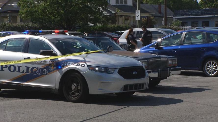 South 3rd Kroger shooting 8-11-20.jpeg LMPD car with crime tape in Kroger parking lot